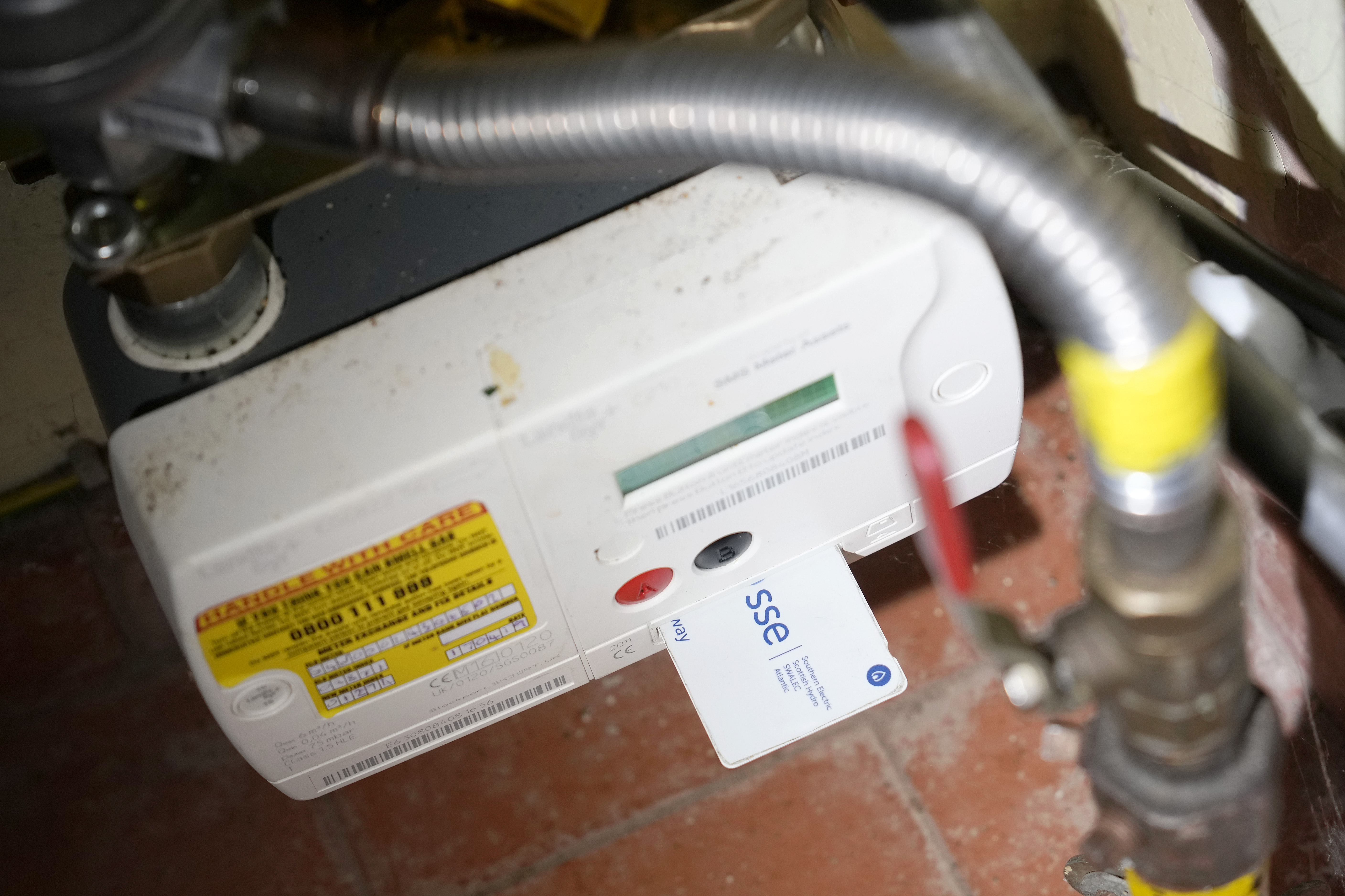Photo illustration of a prepayment gas meter and card in a home.