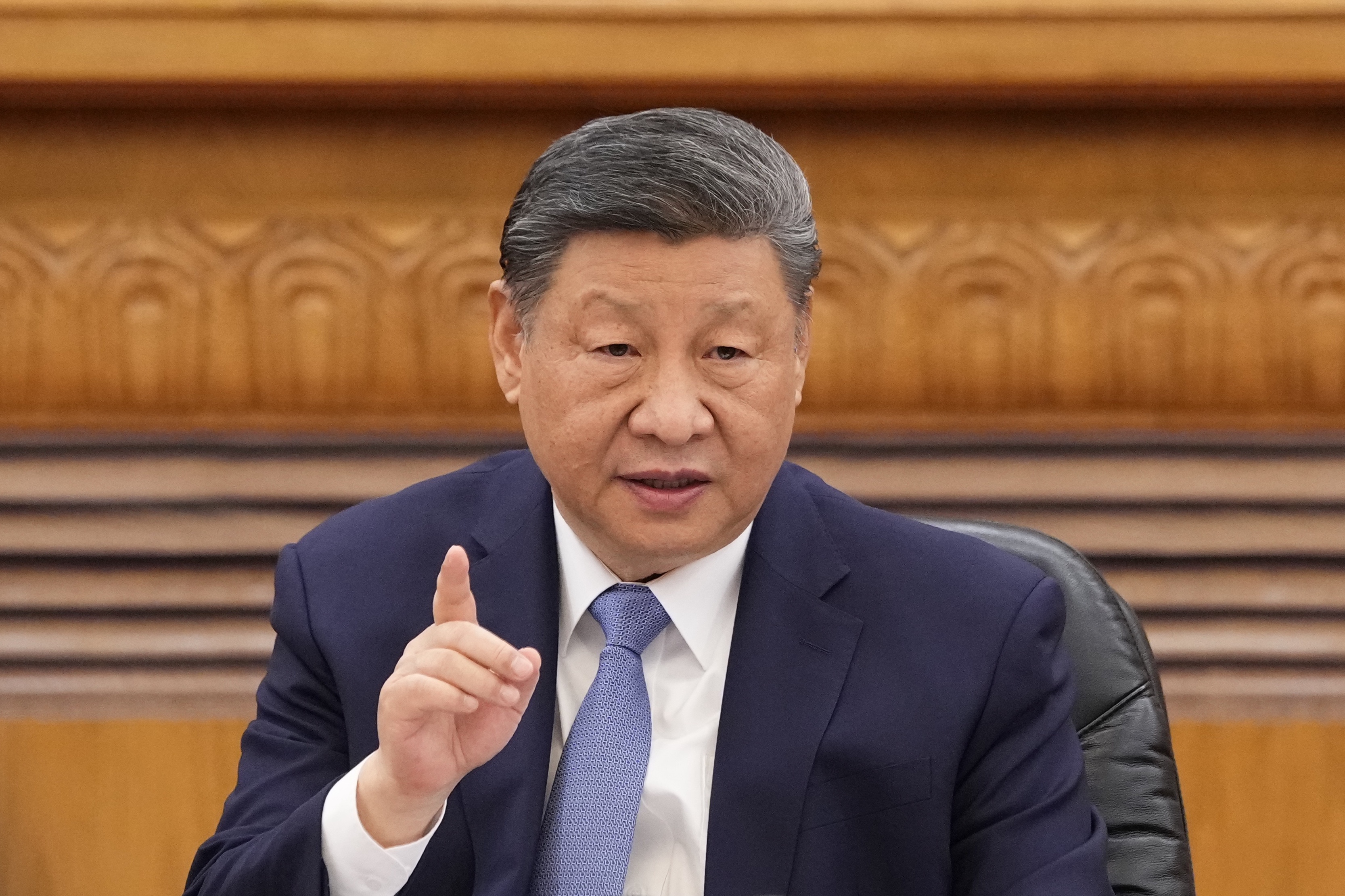 Xi Jinping speaking at a meeting with global business leaders.