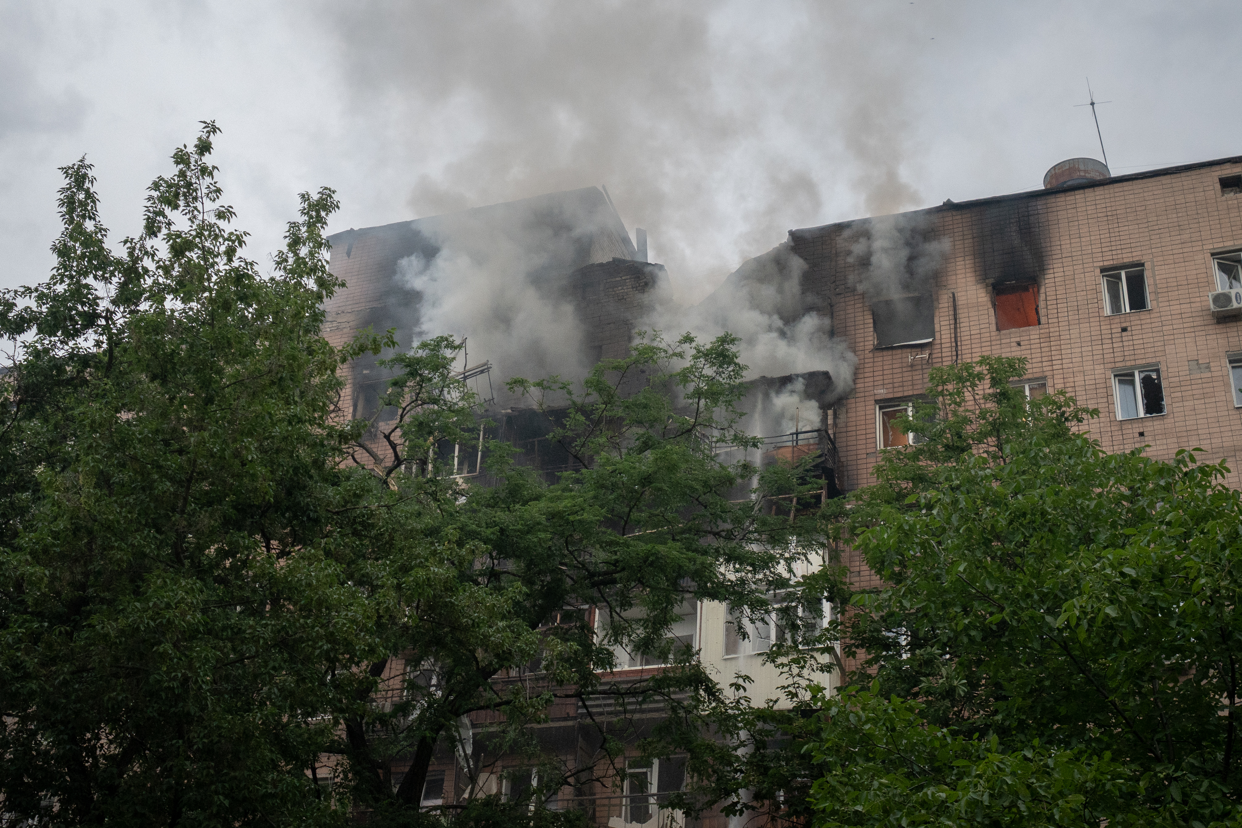 Smoke rises from a damaged residential building in Kharkiv, Ukraine, after a Russian air attack.