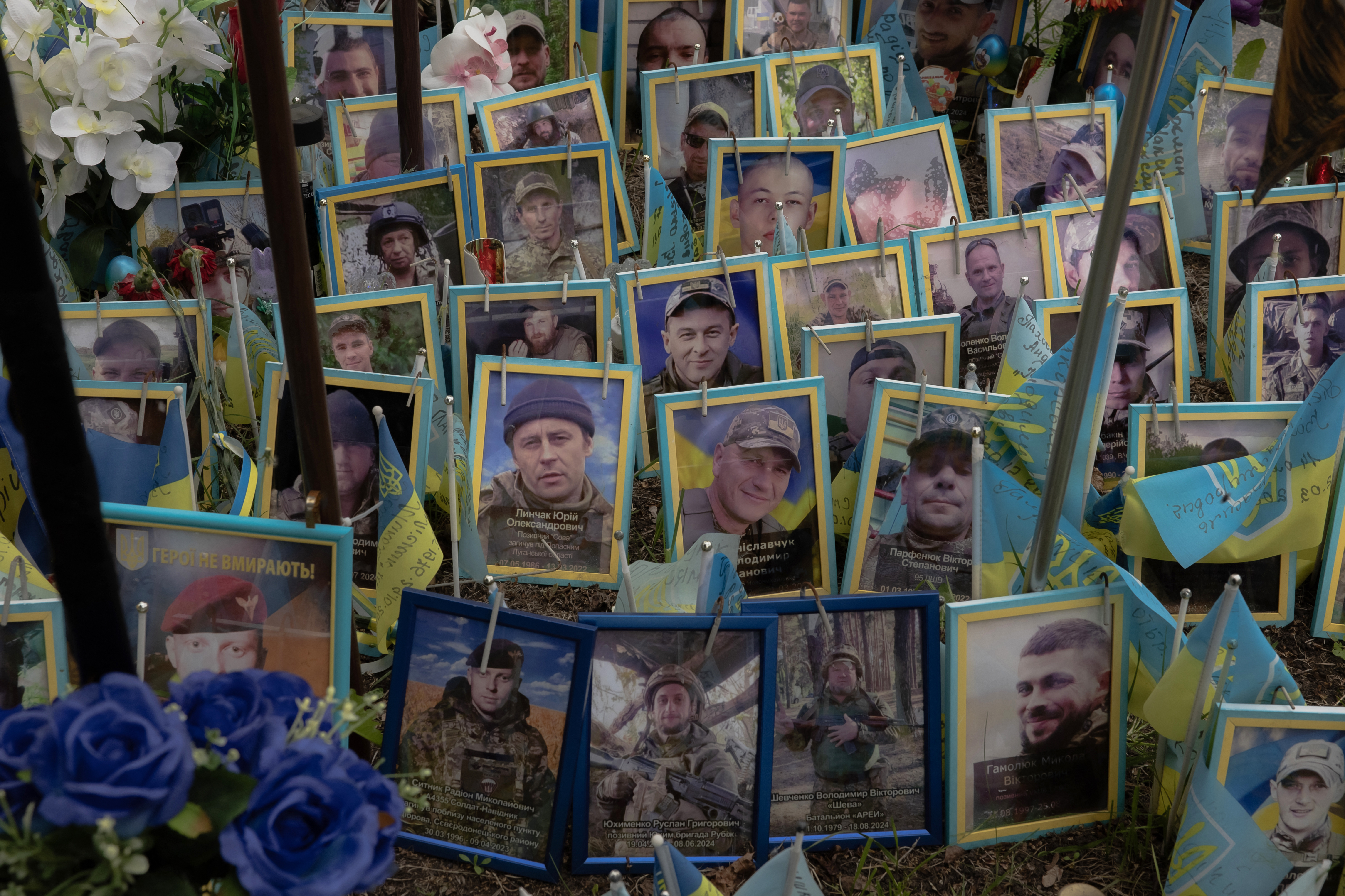 Memorial with photos of fallen Ukrainian soldiers.