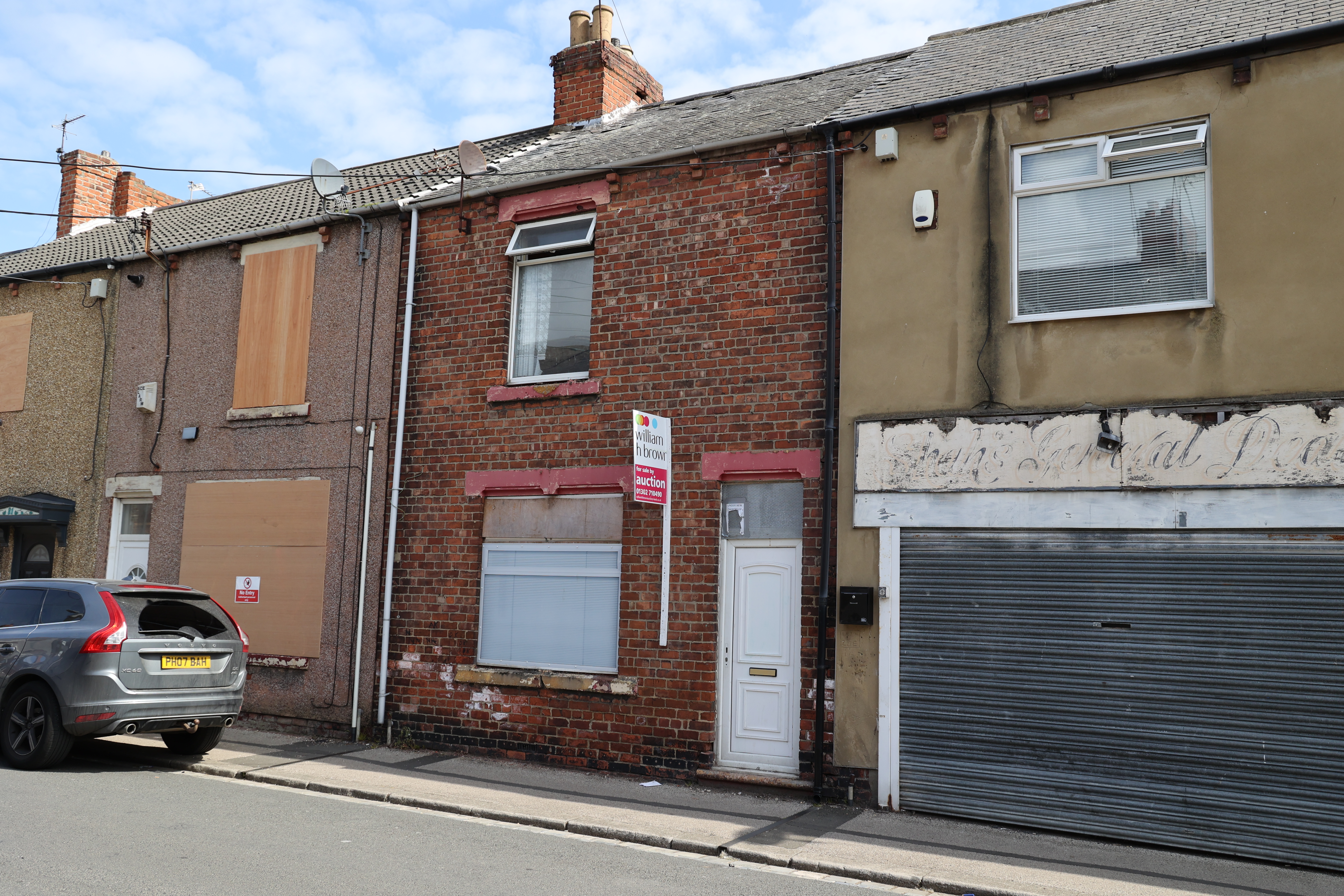 A three-bed home for sale at auction; the property needs refurbishment.