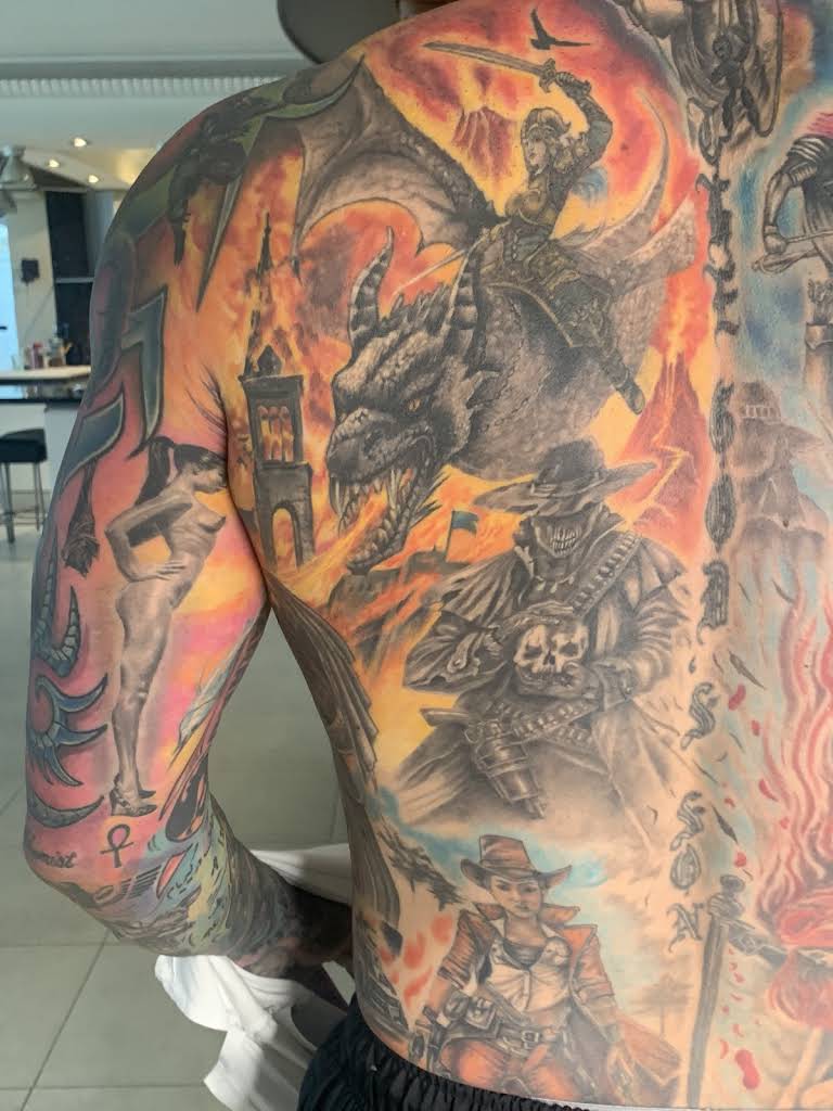 Large back tattoo depicting a dragon, a woman riding the dragon, and several other figures.