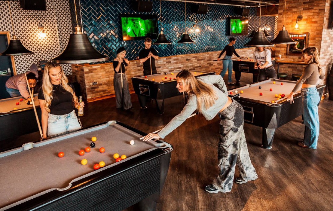 People playing pool in a pub.