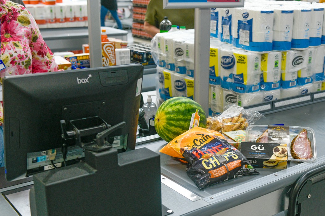 Groceries on a checkout conveyor belt.