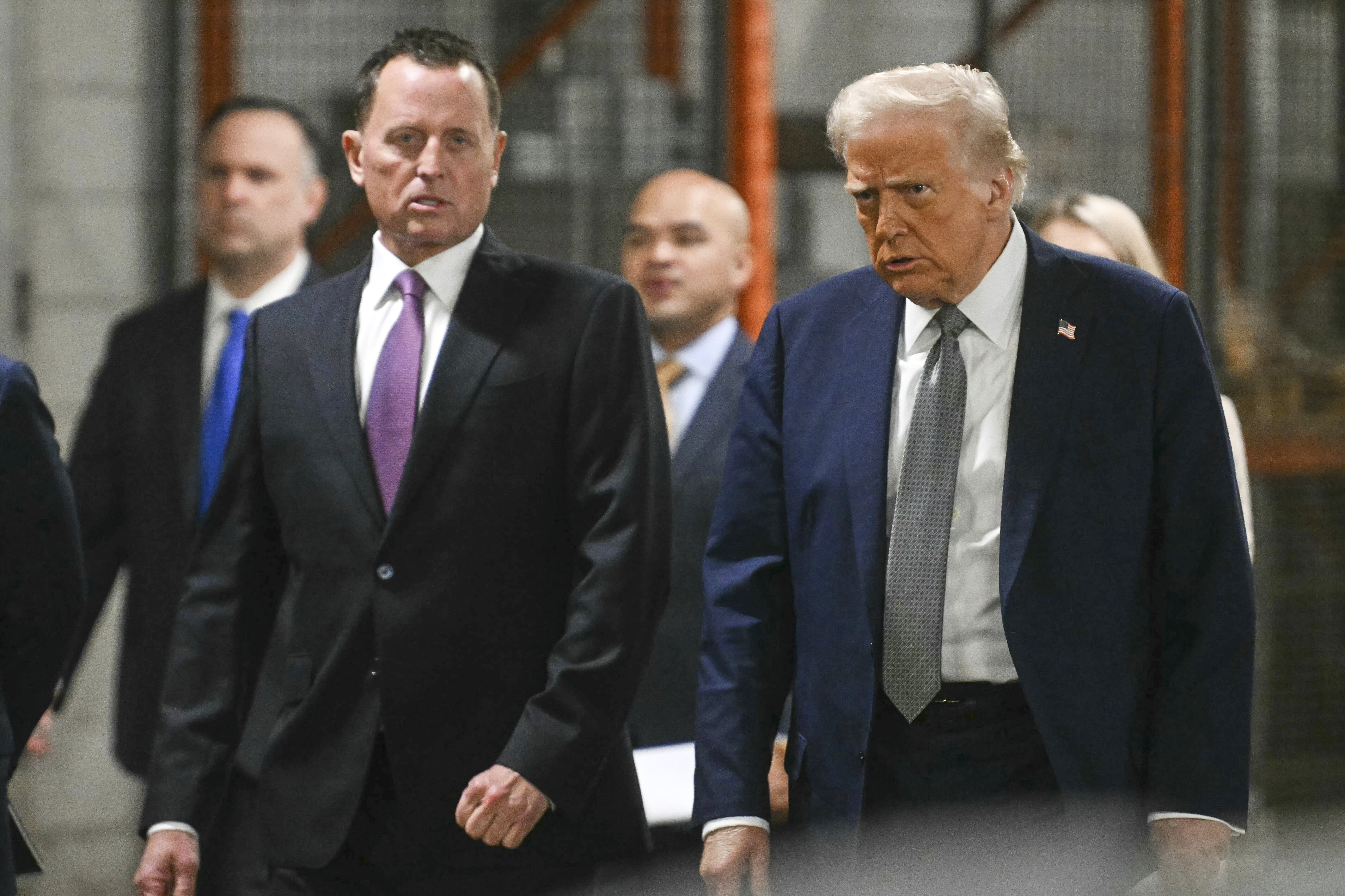 President Trump (right) walks with special envoy and interim Kennedy Center executive director Ric Grenell March 17.