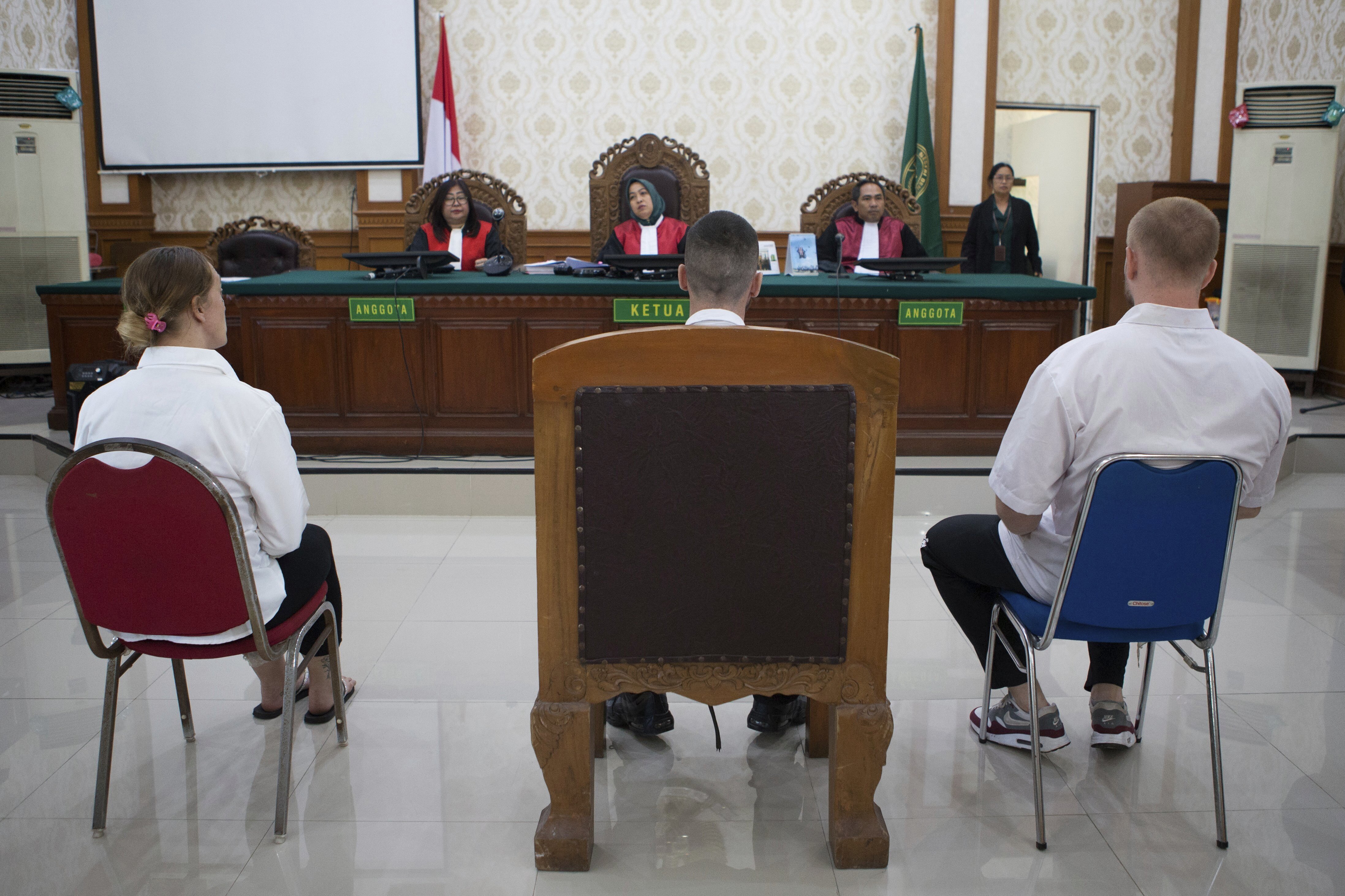 Three defendants sit in court during a drug trial in Bali, Indonesia.