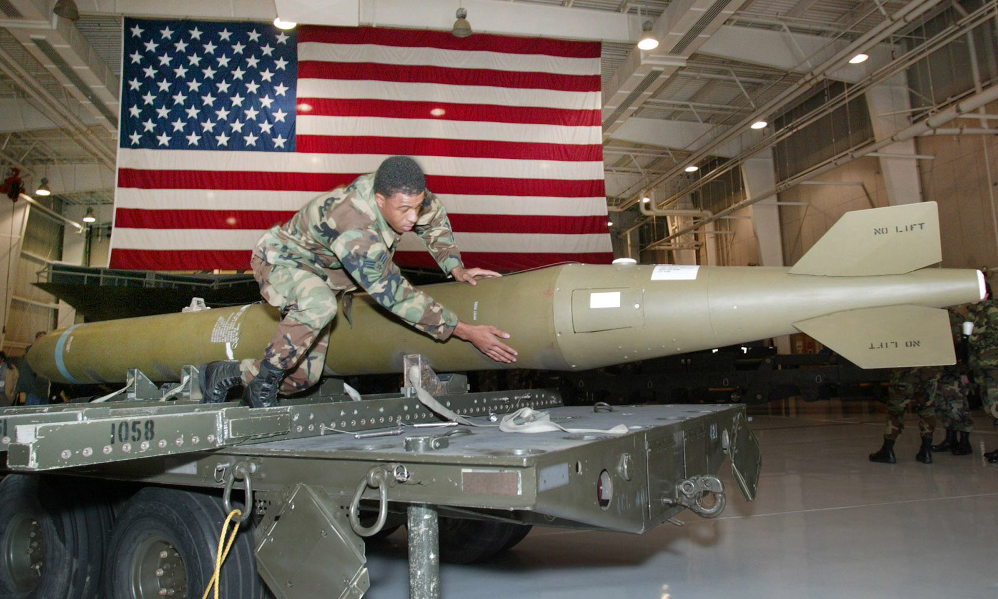 Airman inspecting a 5000-pound GBU-37 bunker buster bomb.