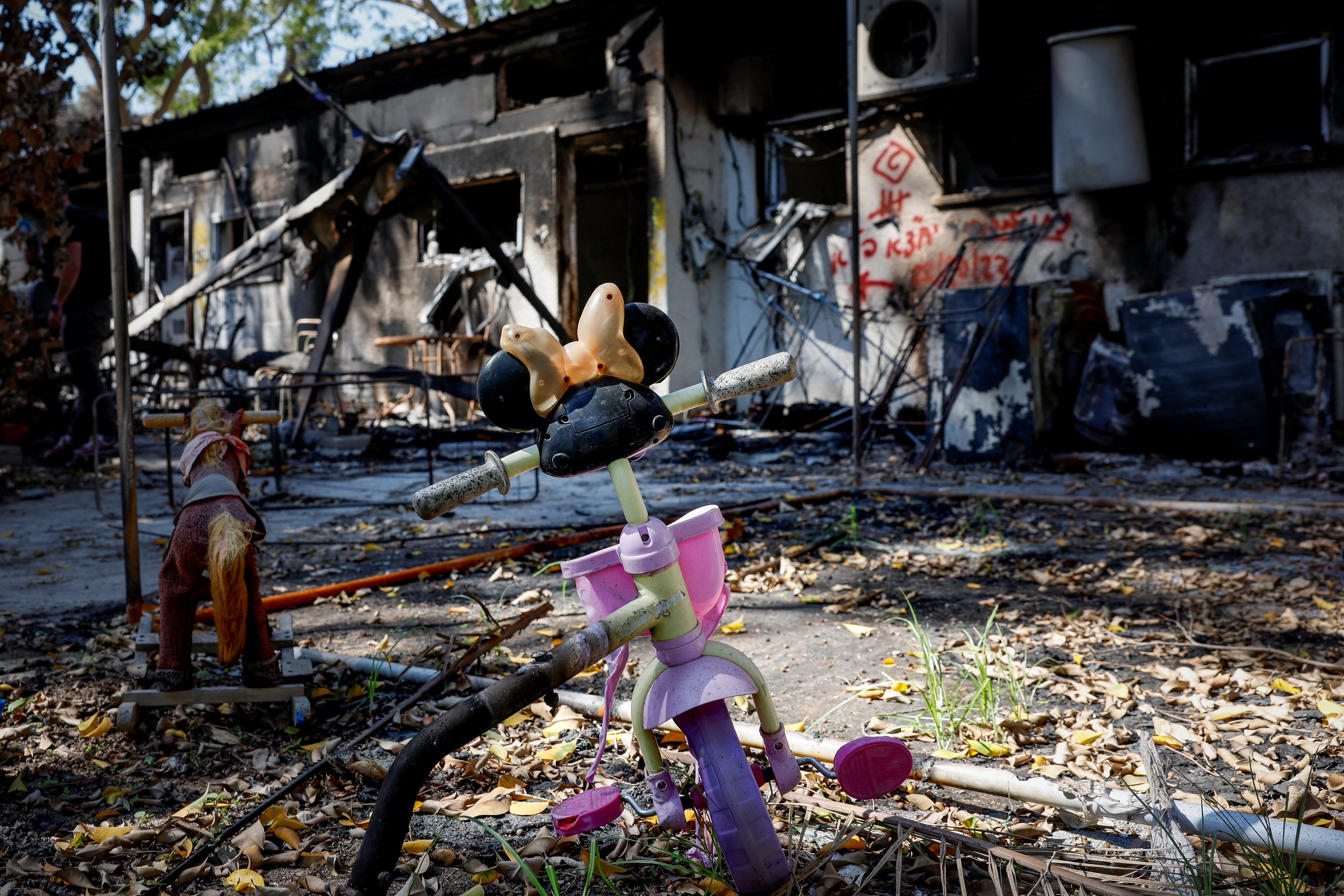 A bicycle sits outside a destroyed house at Kibbutz Nir Oz after Hamas' attack on Oct. 30, 2023.