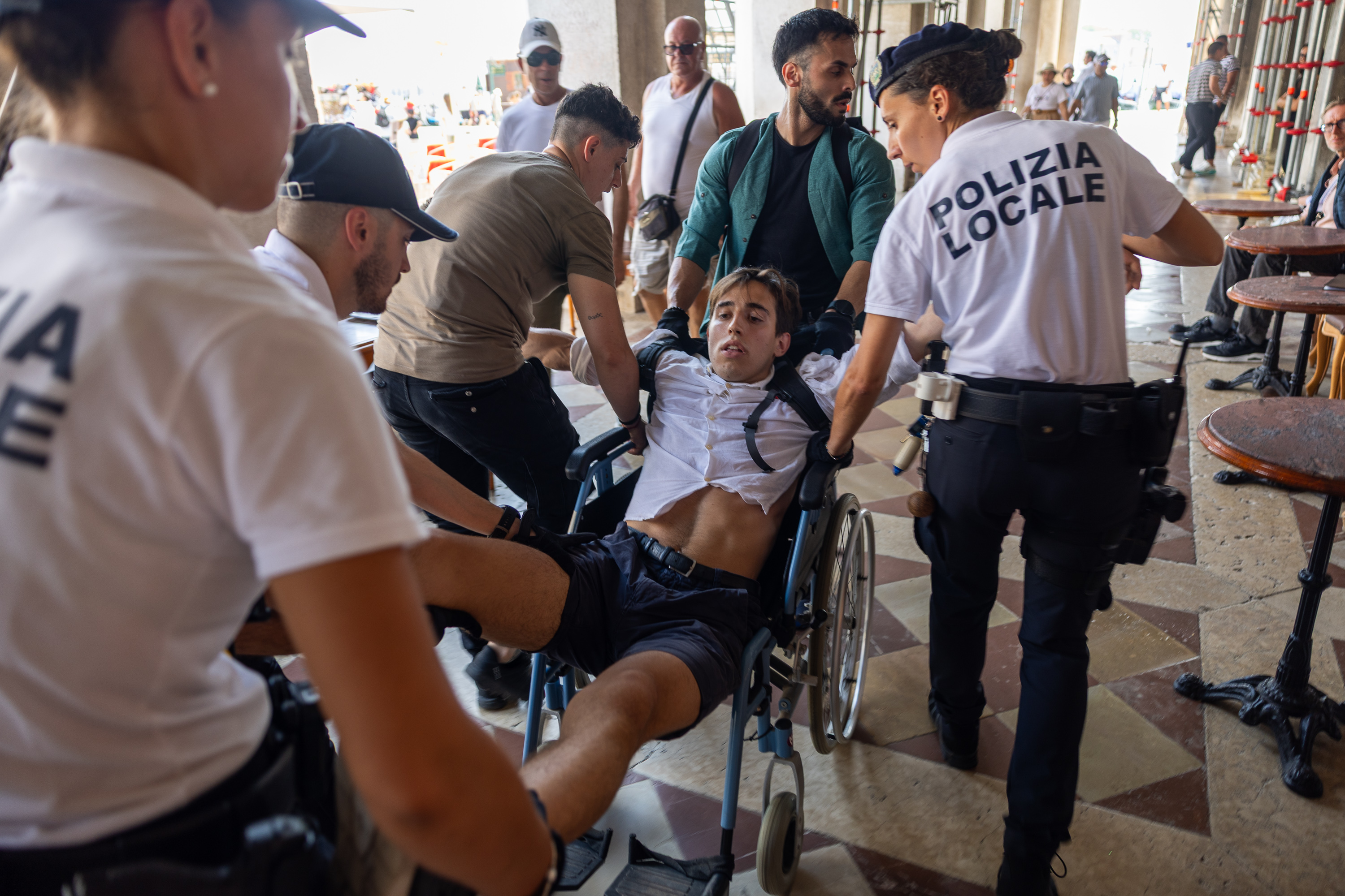 Police removing a protester from a wheelchair during a protest in Venice.