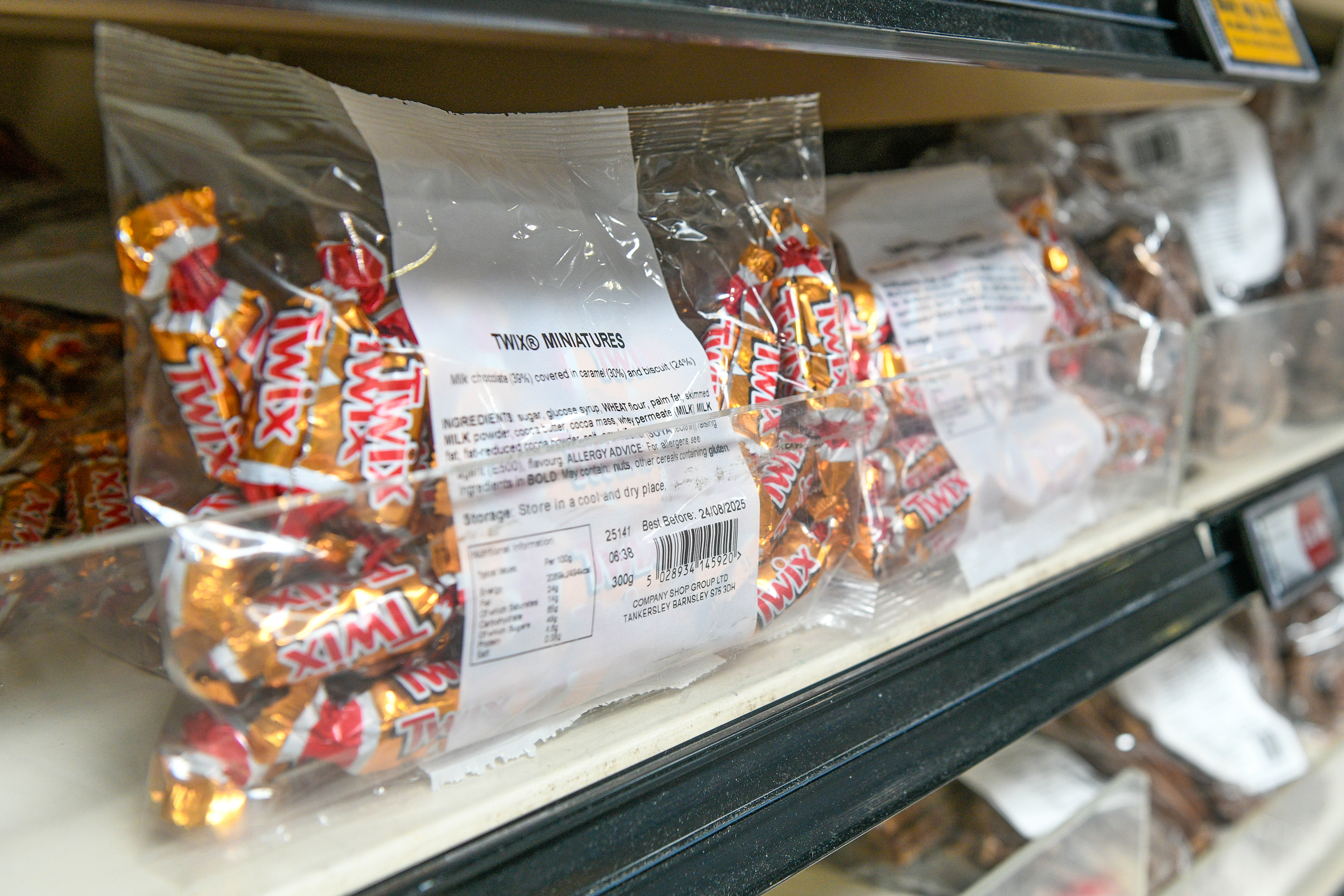 Bag of Twix miniatures on a store shelf.