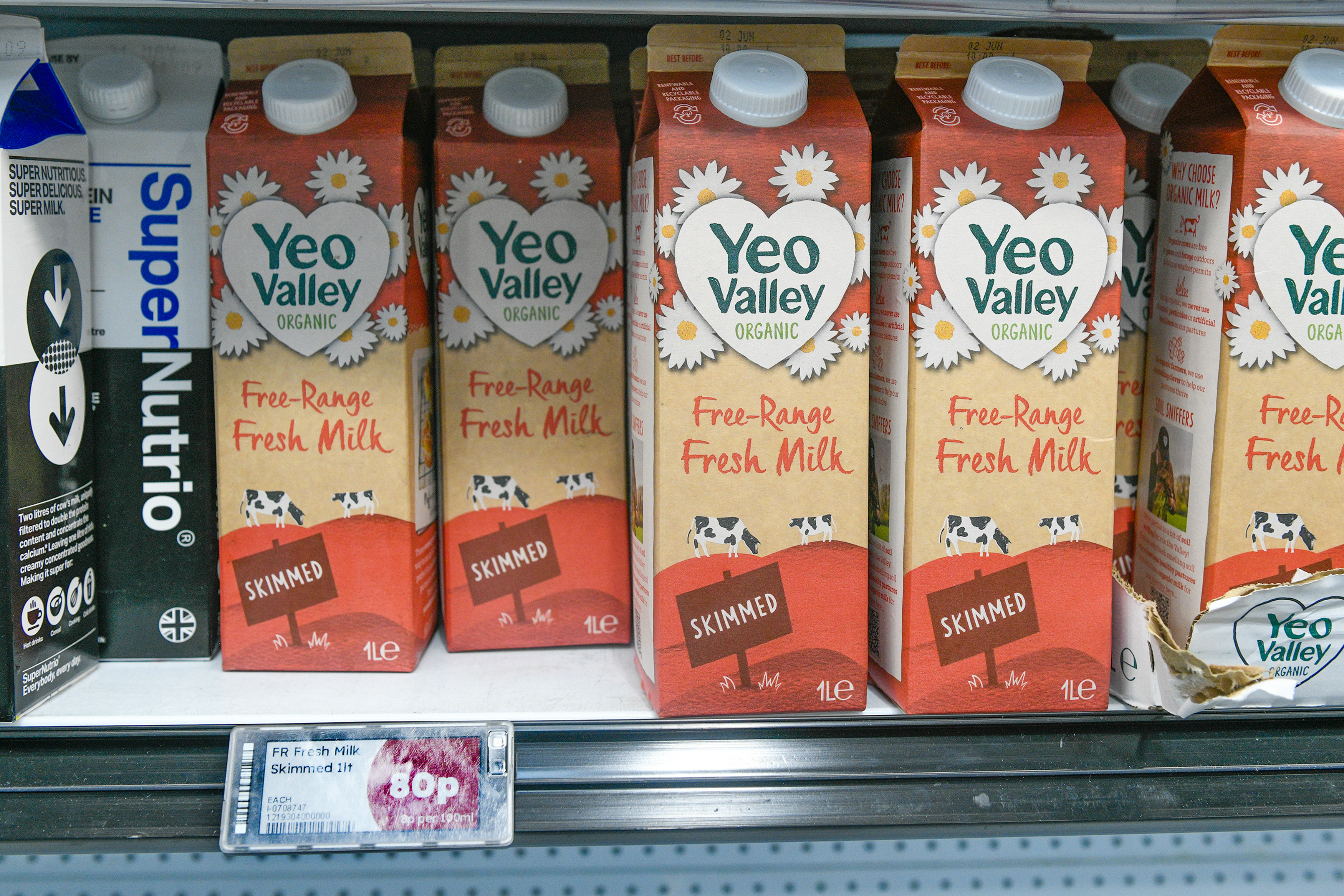 Several cartons of Yeo Valley Organic free-range skimmed milk on a store shelf.