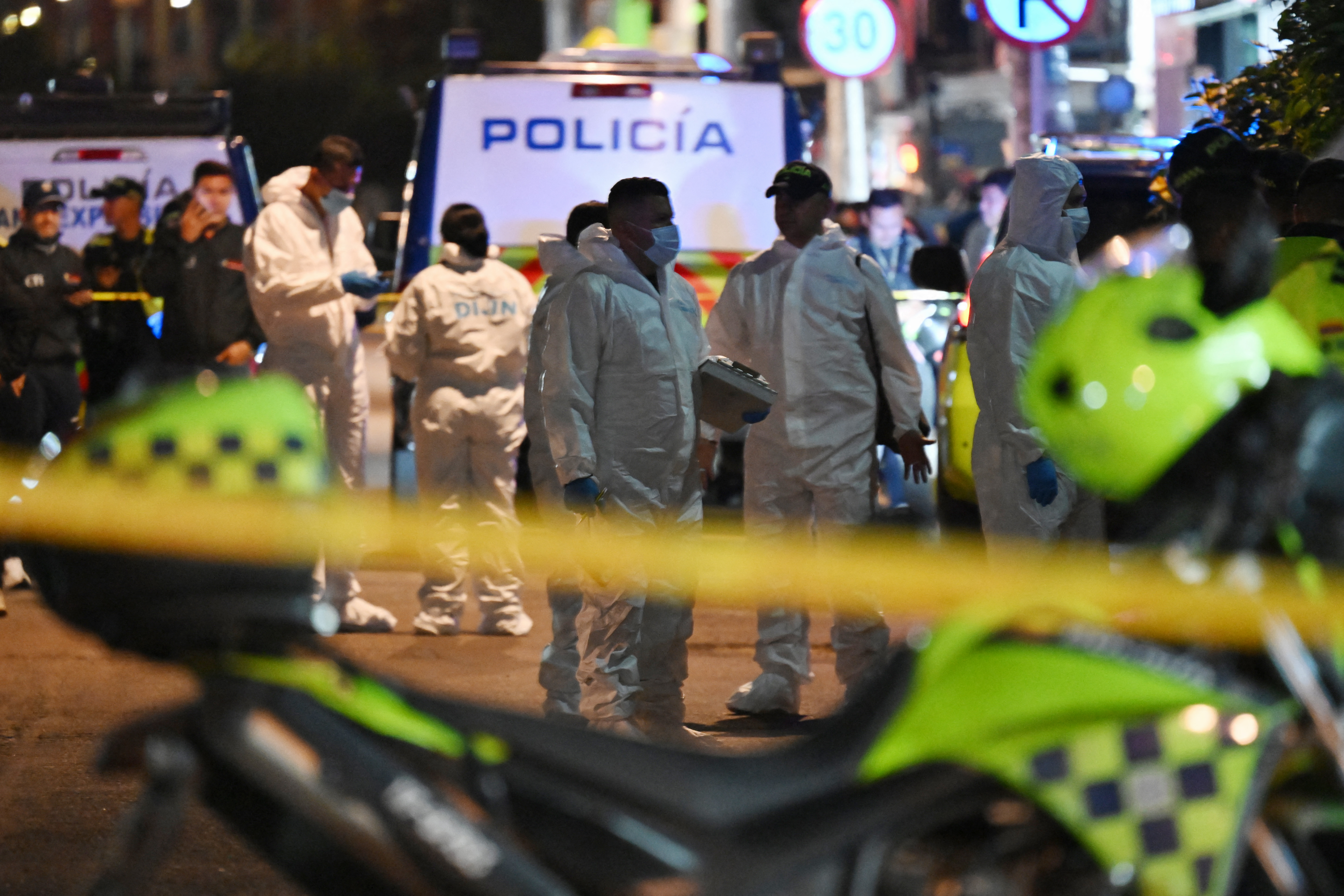 Forensic experts gather at the scene to investigate the shooting of Uribe in the Modelia neighborhood of Bogota.