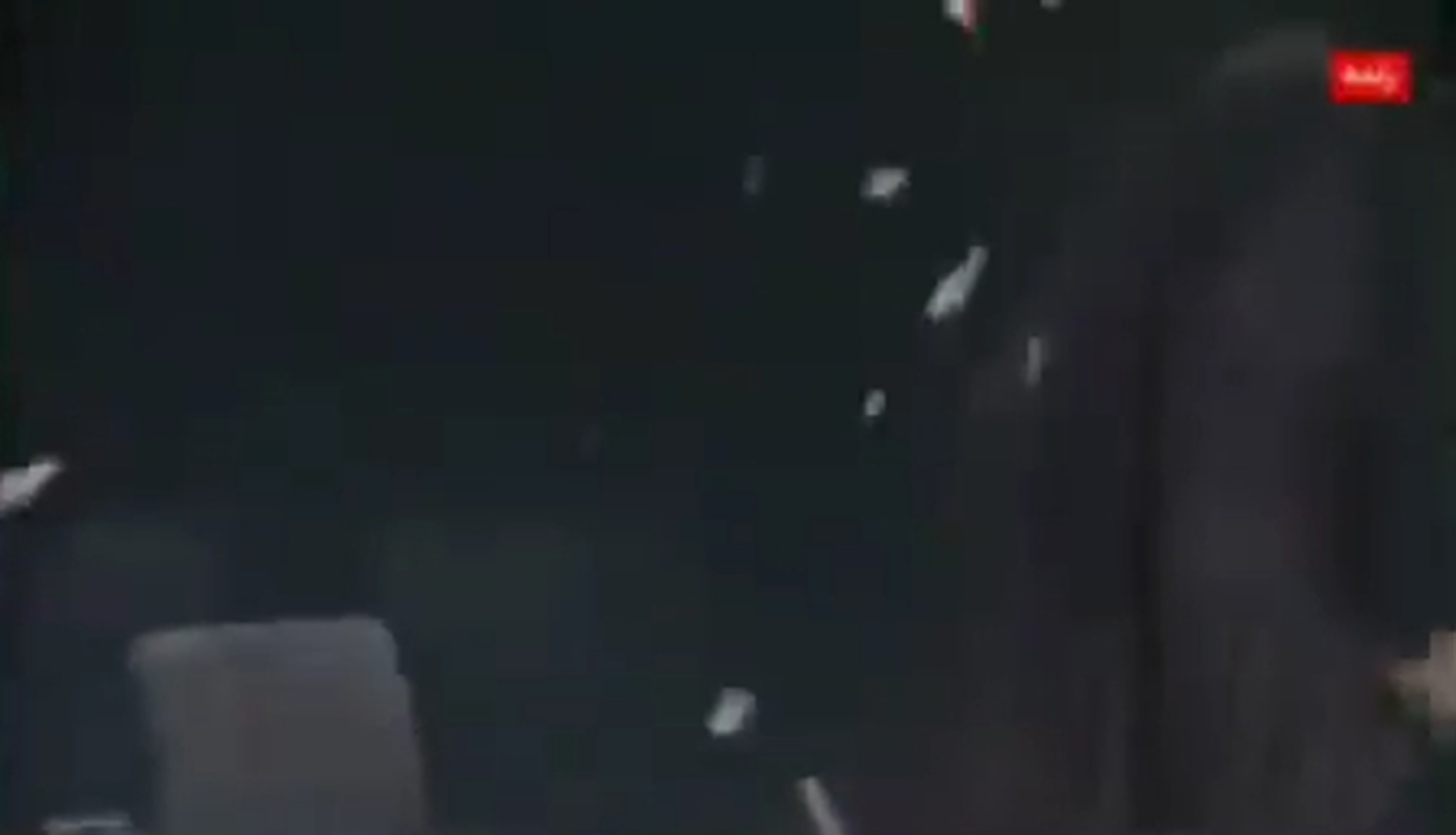 Debris from the strike seen falling into the view of the camera.
