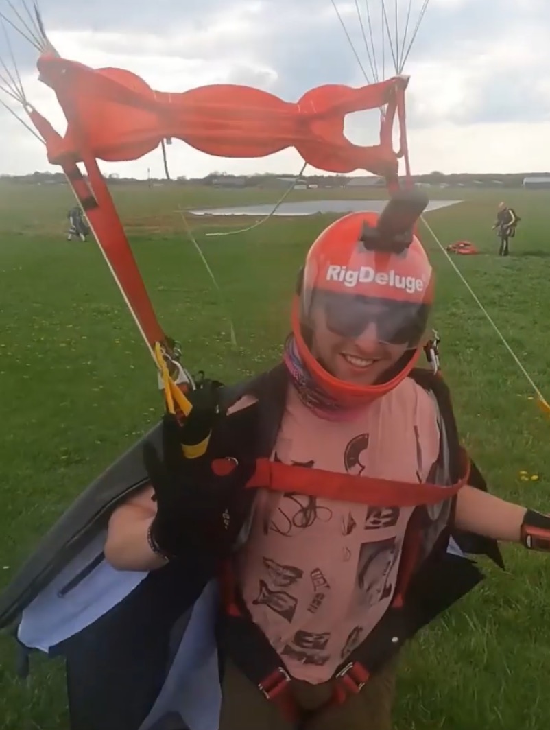 Wingsuit flier smiling before a jump.