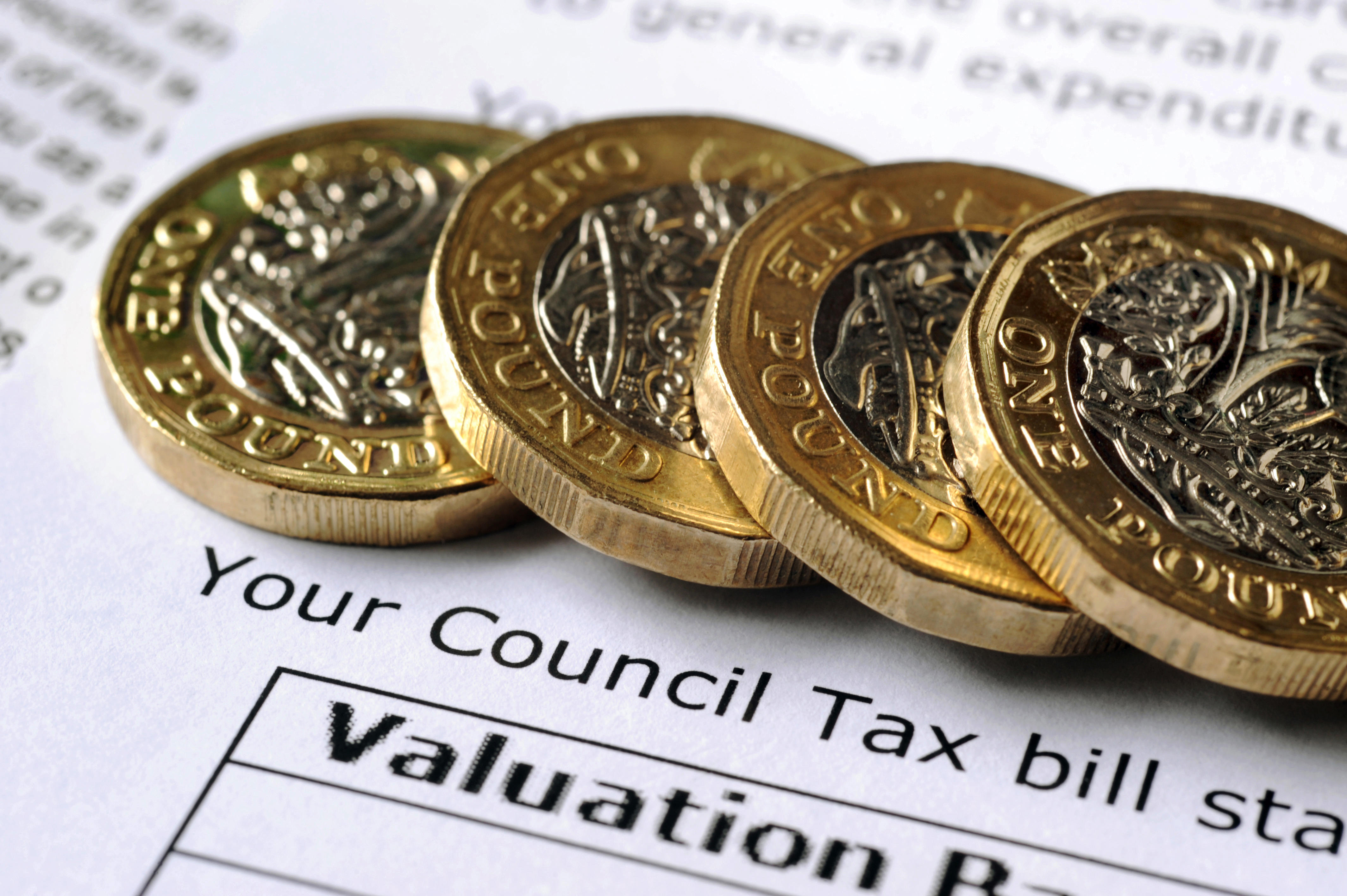 One pound coins on a council tax bill.