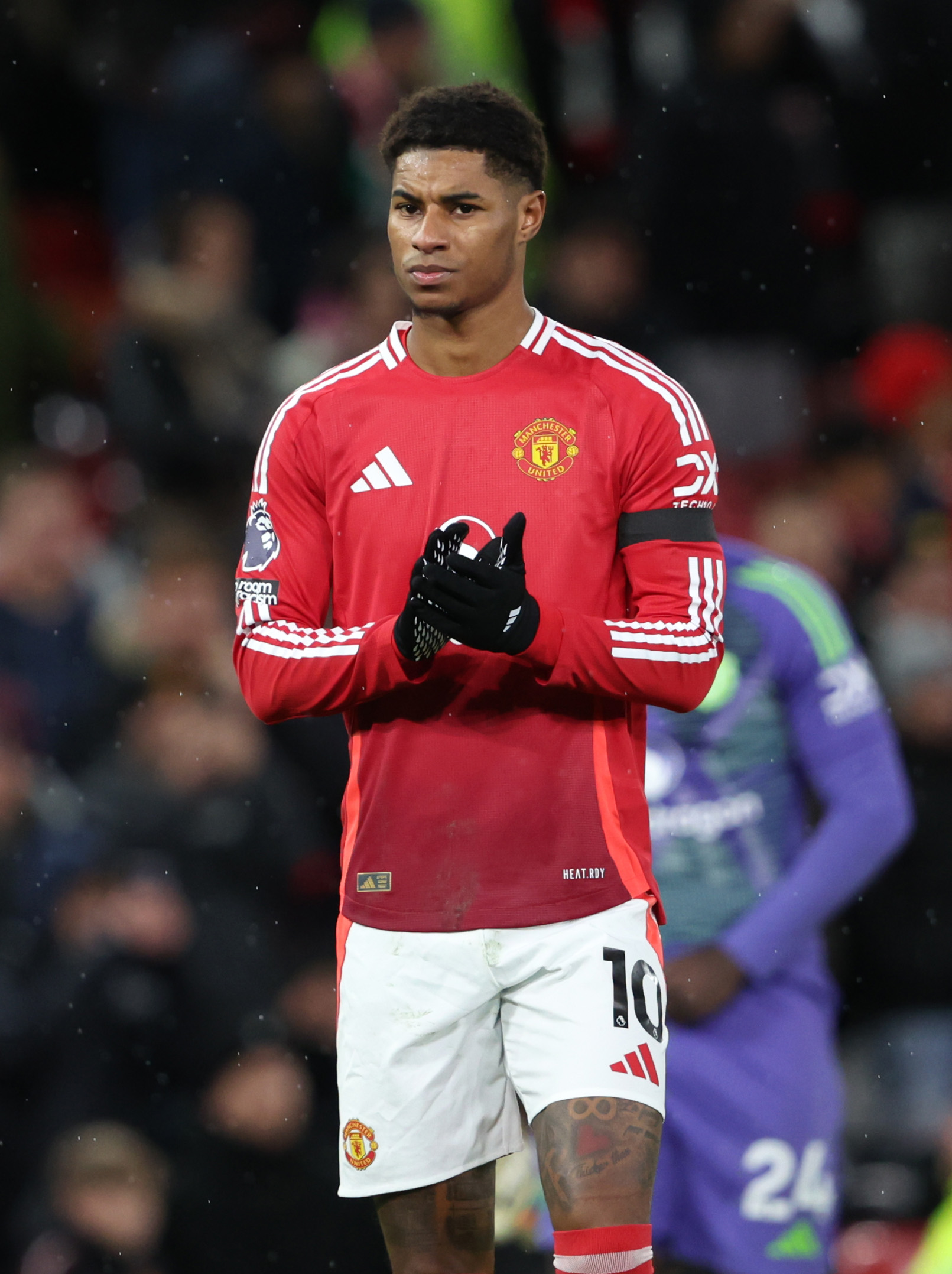 Marcus Rashford of Manchester United applauds fans after a loss.