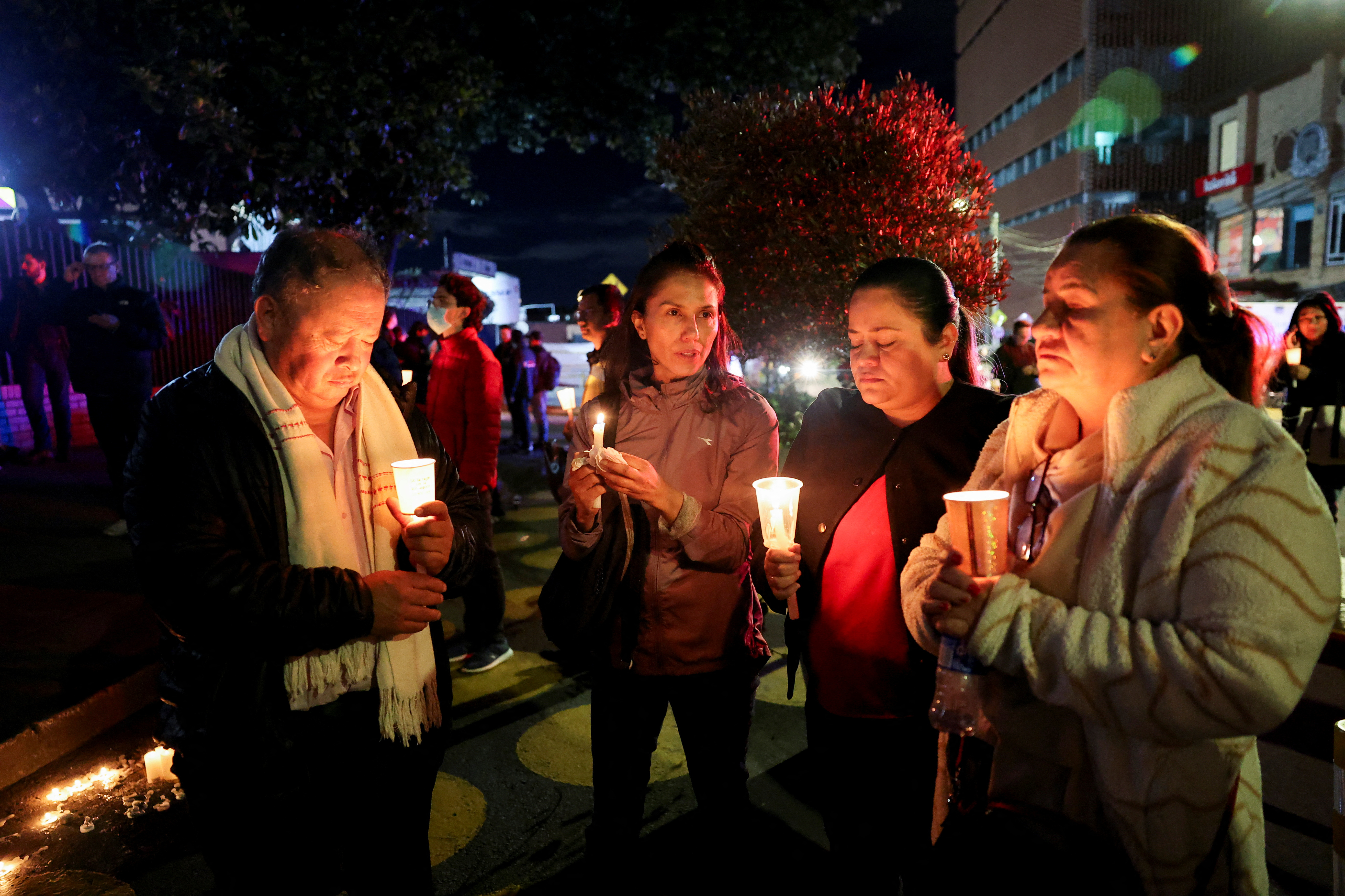 Supporters hold candles and pray outside the Santa Fe Foundation hospital where Uribe was being treated.