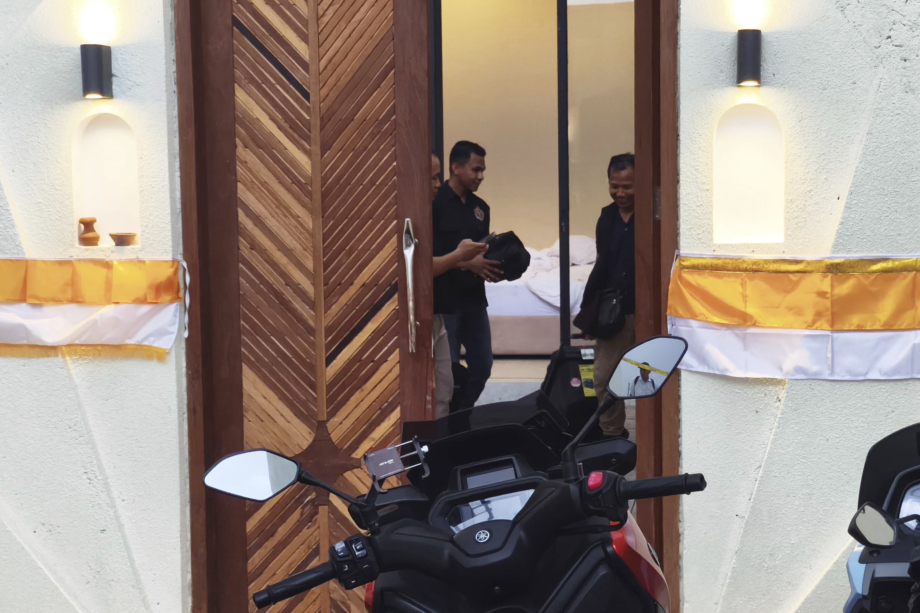 Police officers at a Bali villa where a shooting occurred.