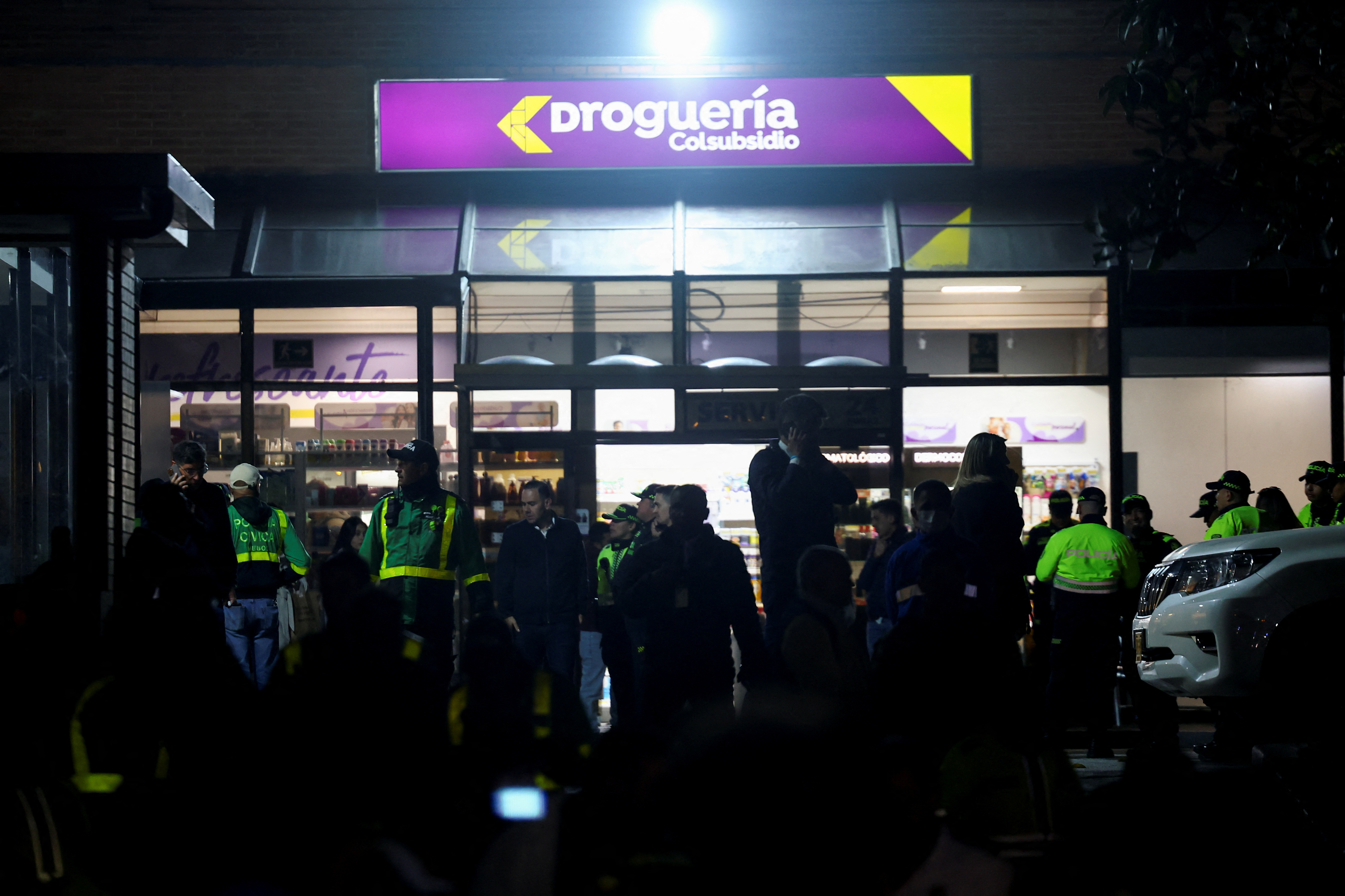 Police officers stand guard outside the Santa Fe Foundation hospital in Bogota, Colombia.
