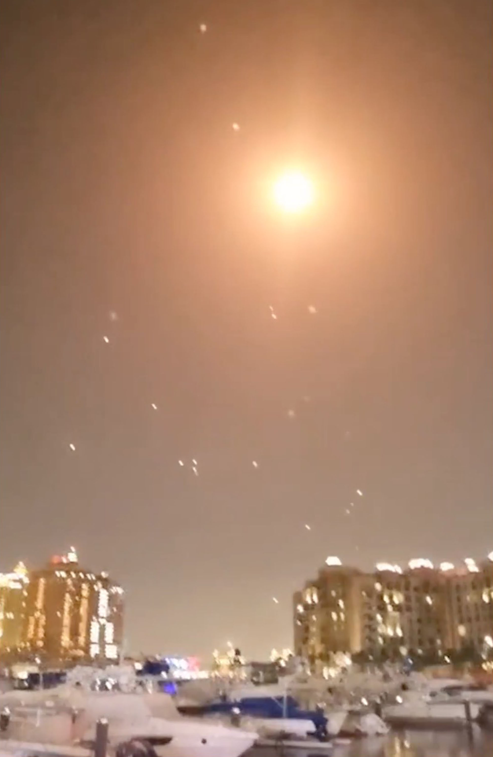 Nighttime video of missile interception over a city.