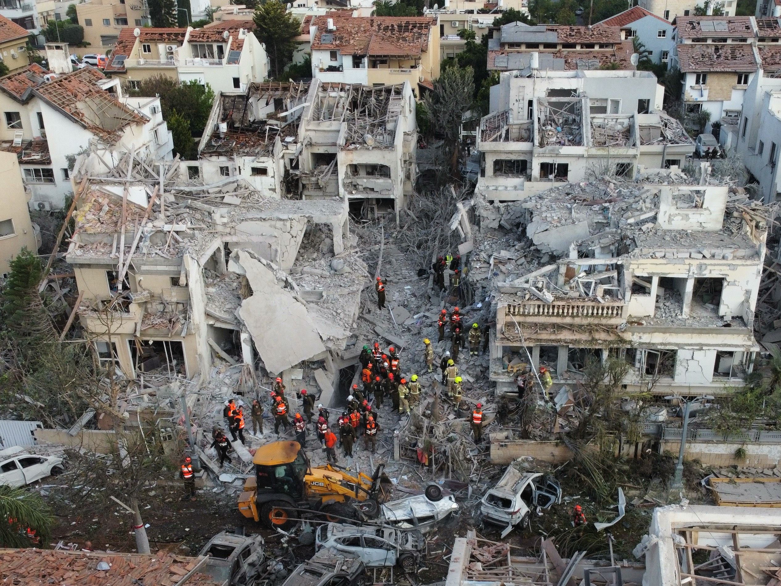 Search teams converge on the site where an Iranian missile hit residential buildings in Rishon LeZion near Tel Aviv, Israel on June 14, 2025.