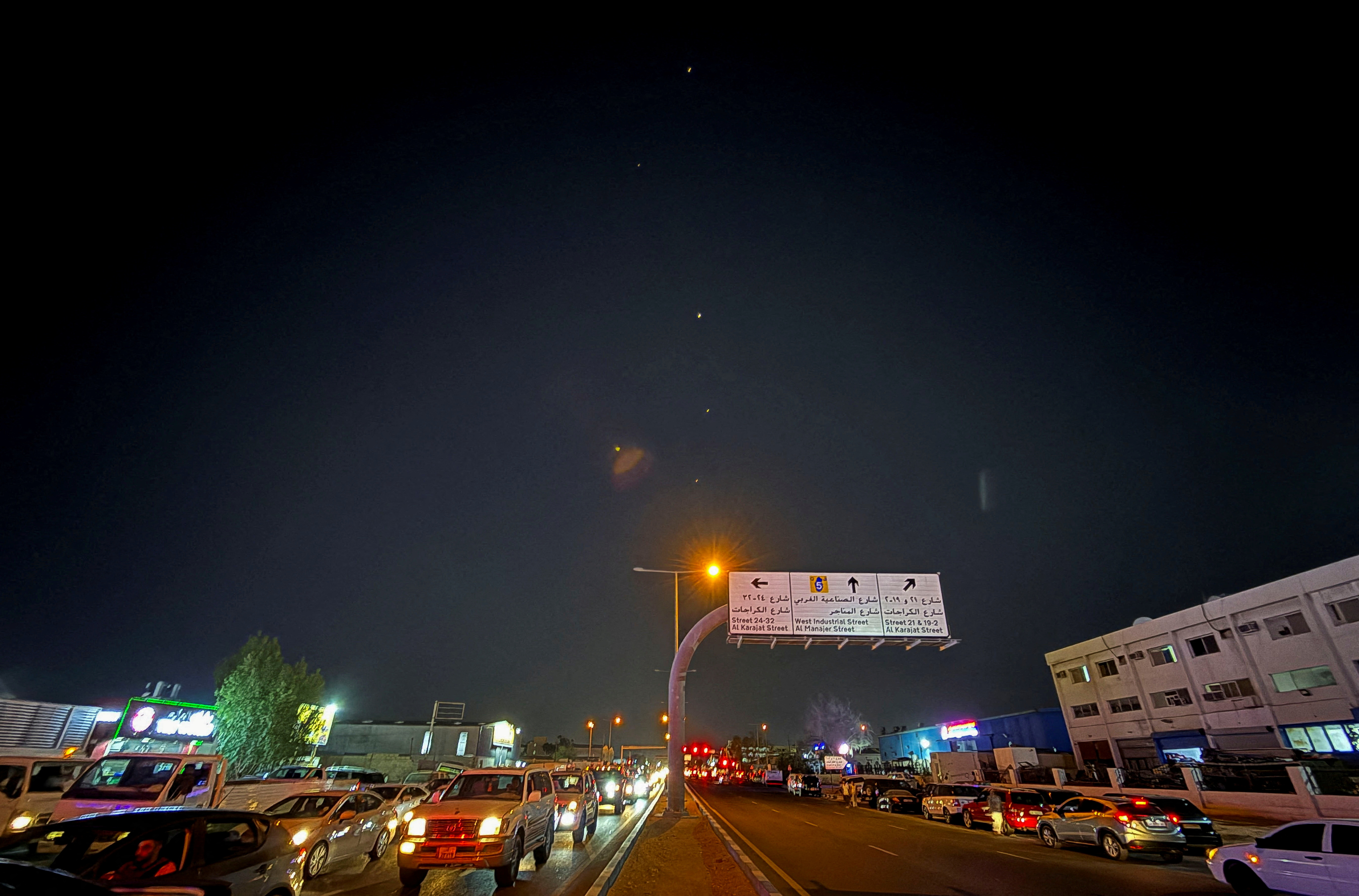 Traces in the night sky over a Doha, Qatar roadway.