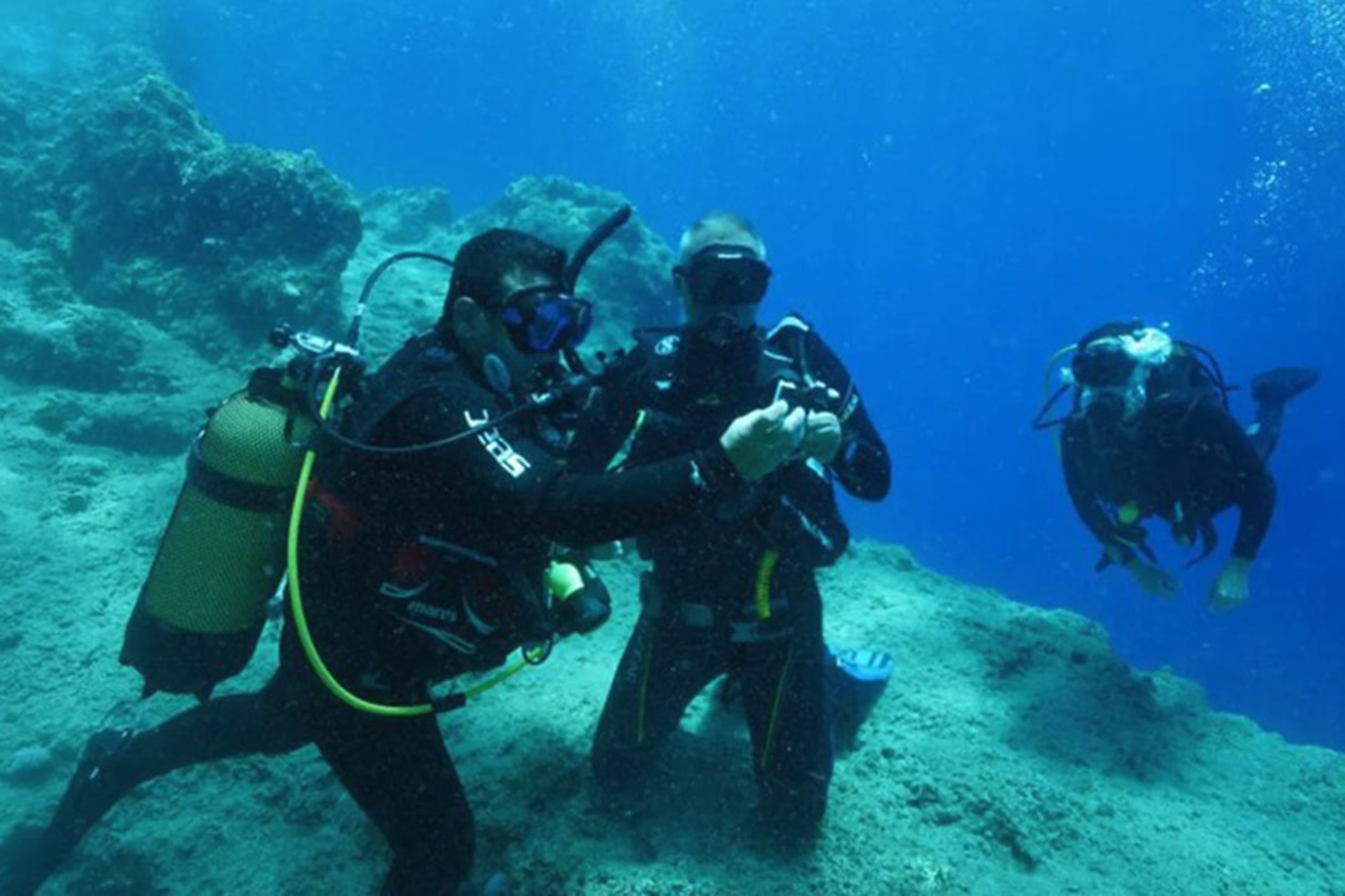 Underwater archaeologists examining a 2,000-year-old shipwreck.
