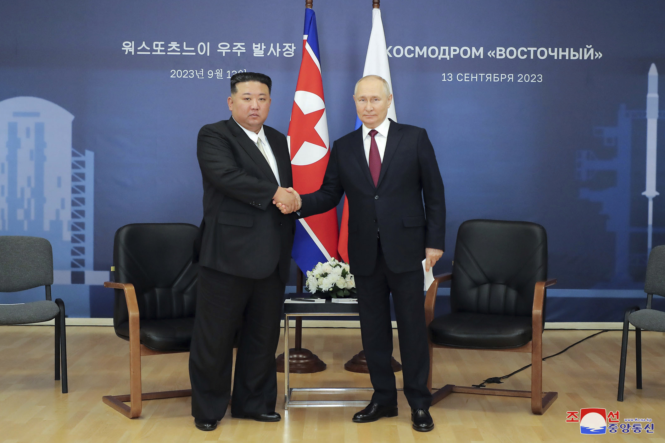 Kim Jong Un and Vladimir Putin shaking hands.