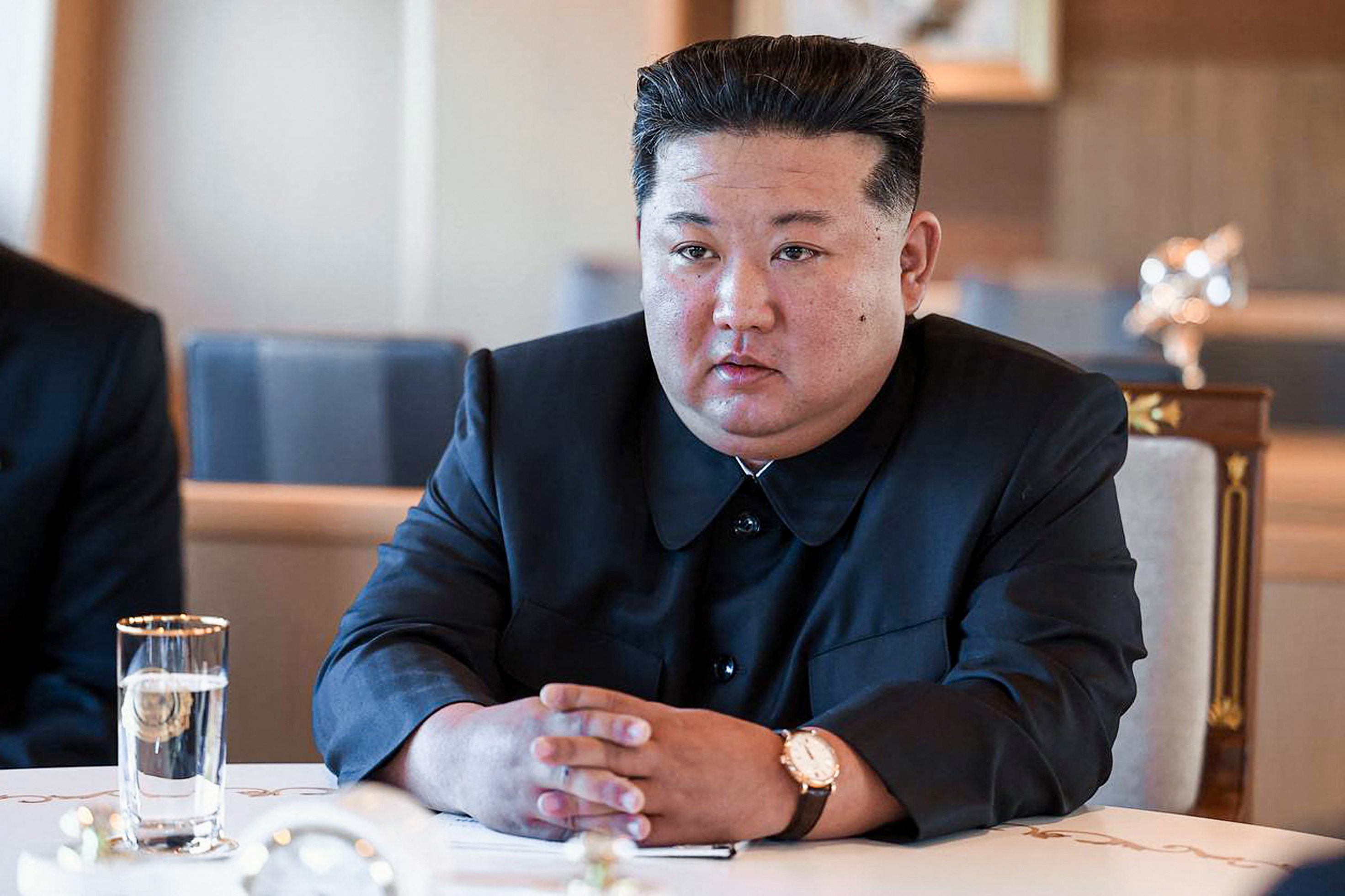 Kim Jong Un seated at a table.