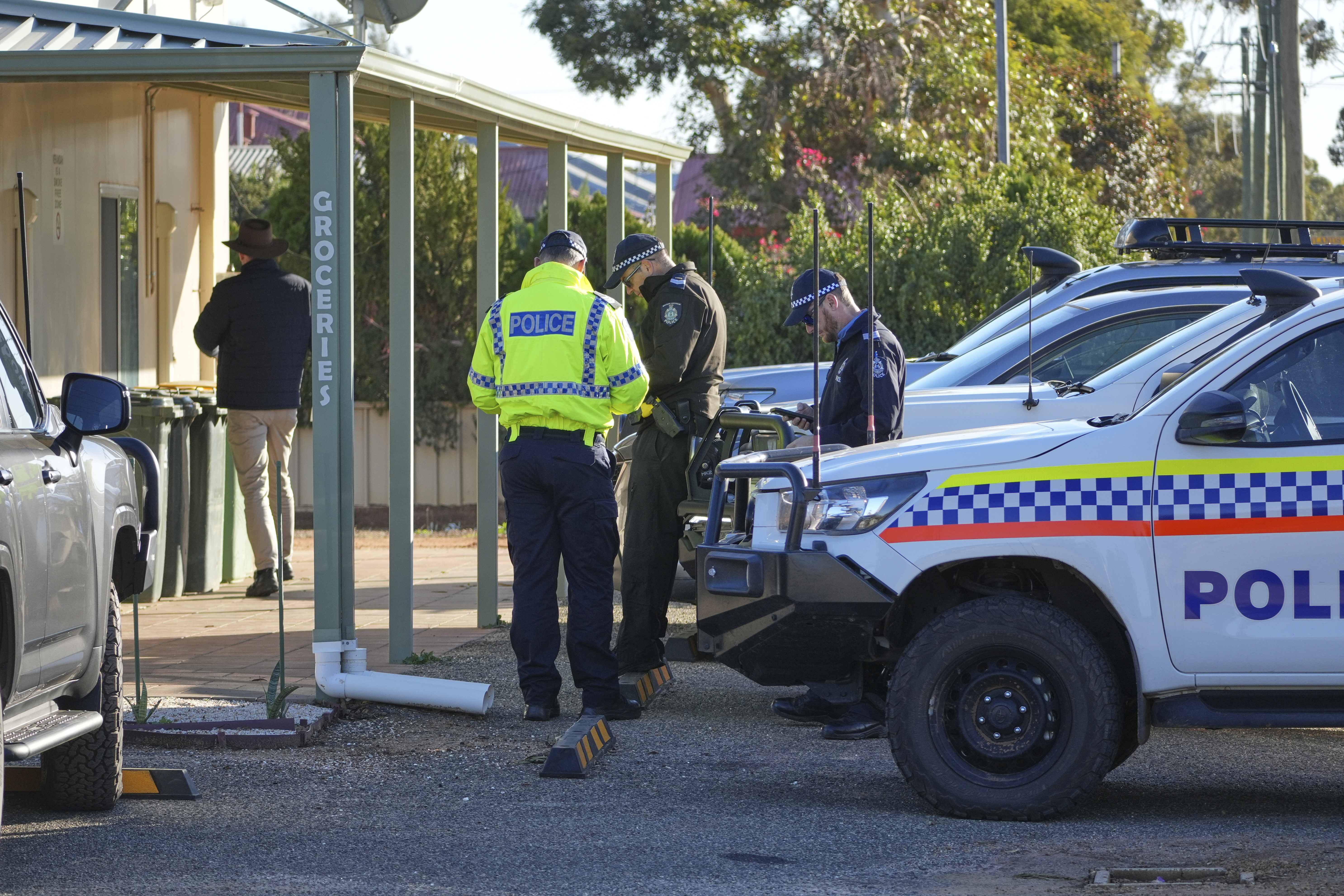 Police officers searching for a missing German backpacker.