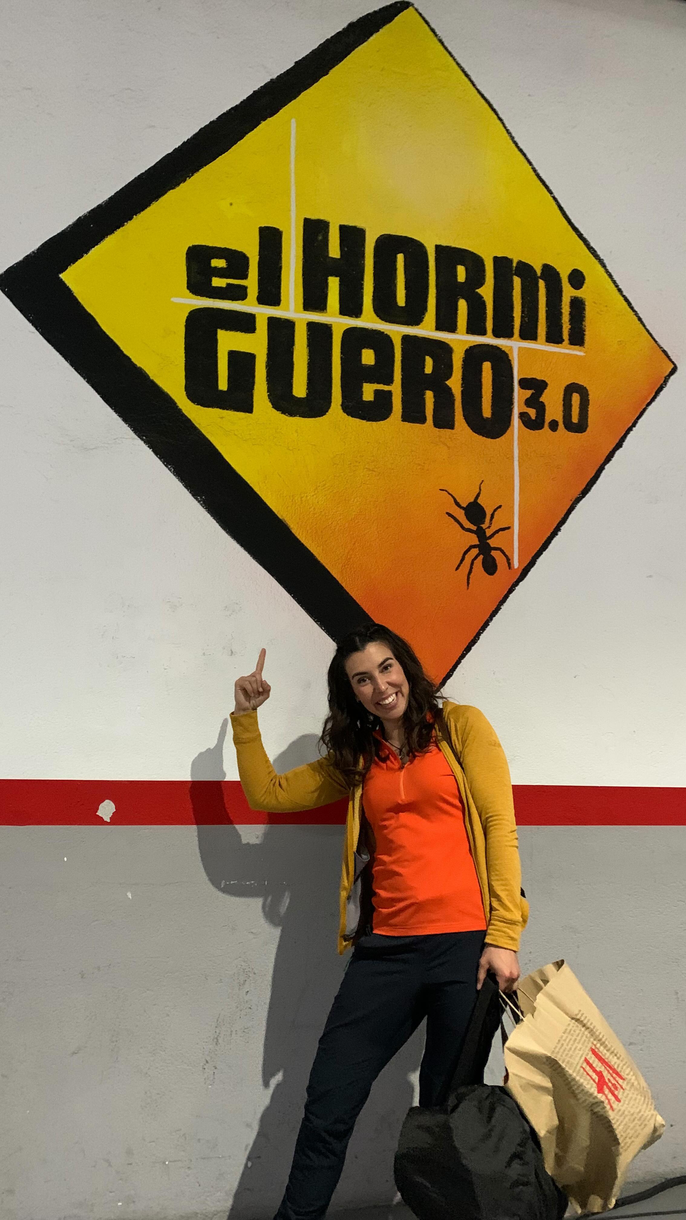 Woman pointing at El Hormiguero 3.0 graffiti.