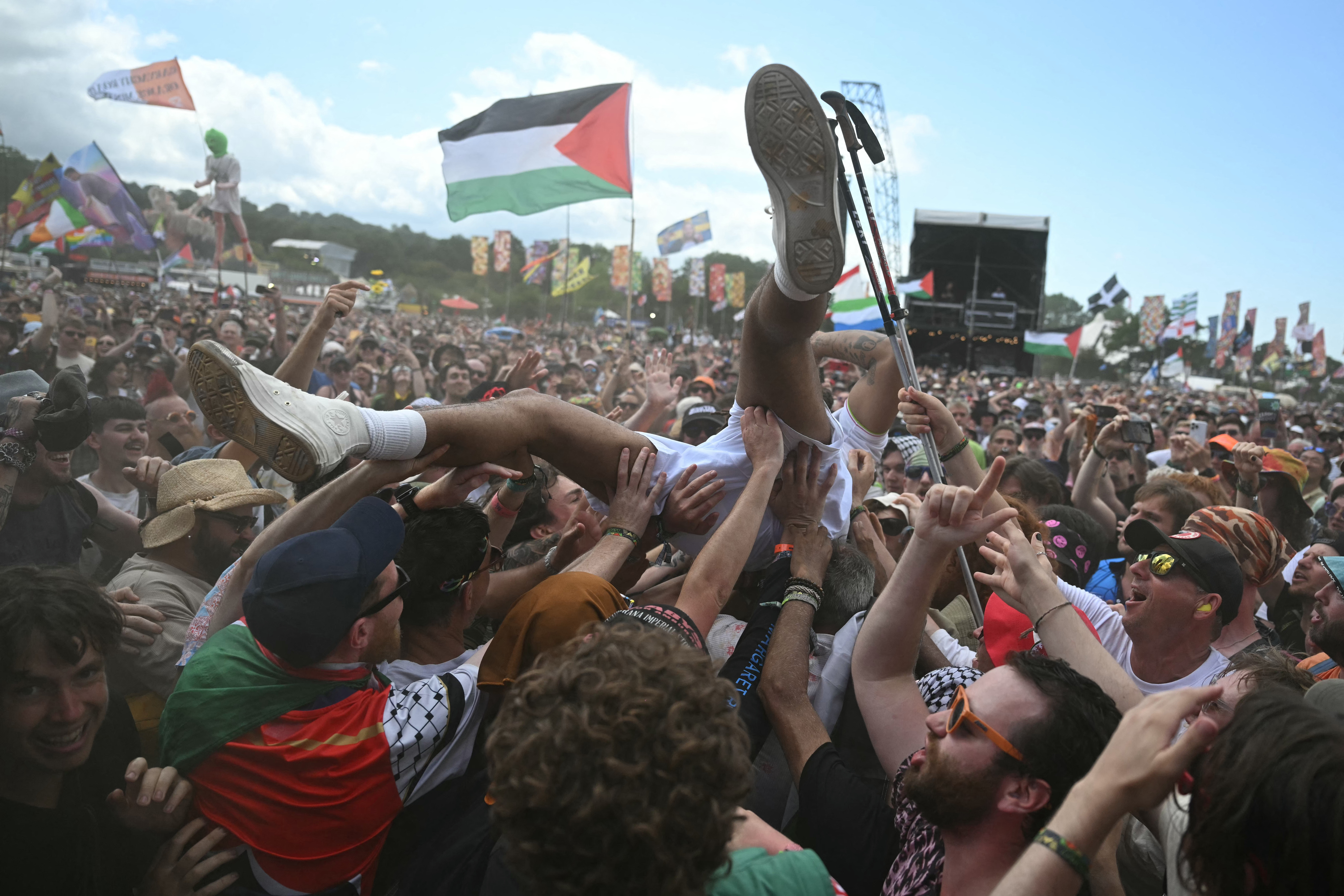 A person crowd surfing at a music festival.