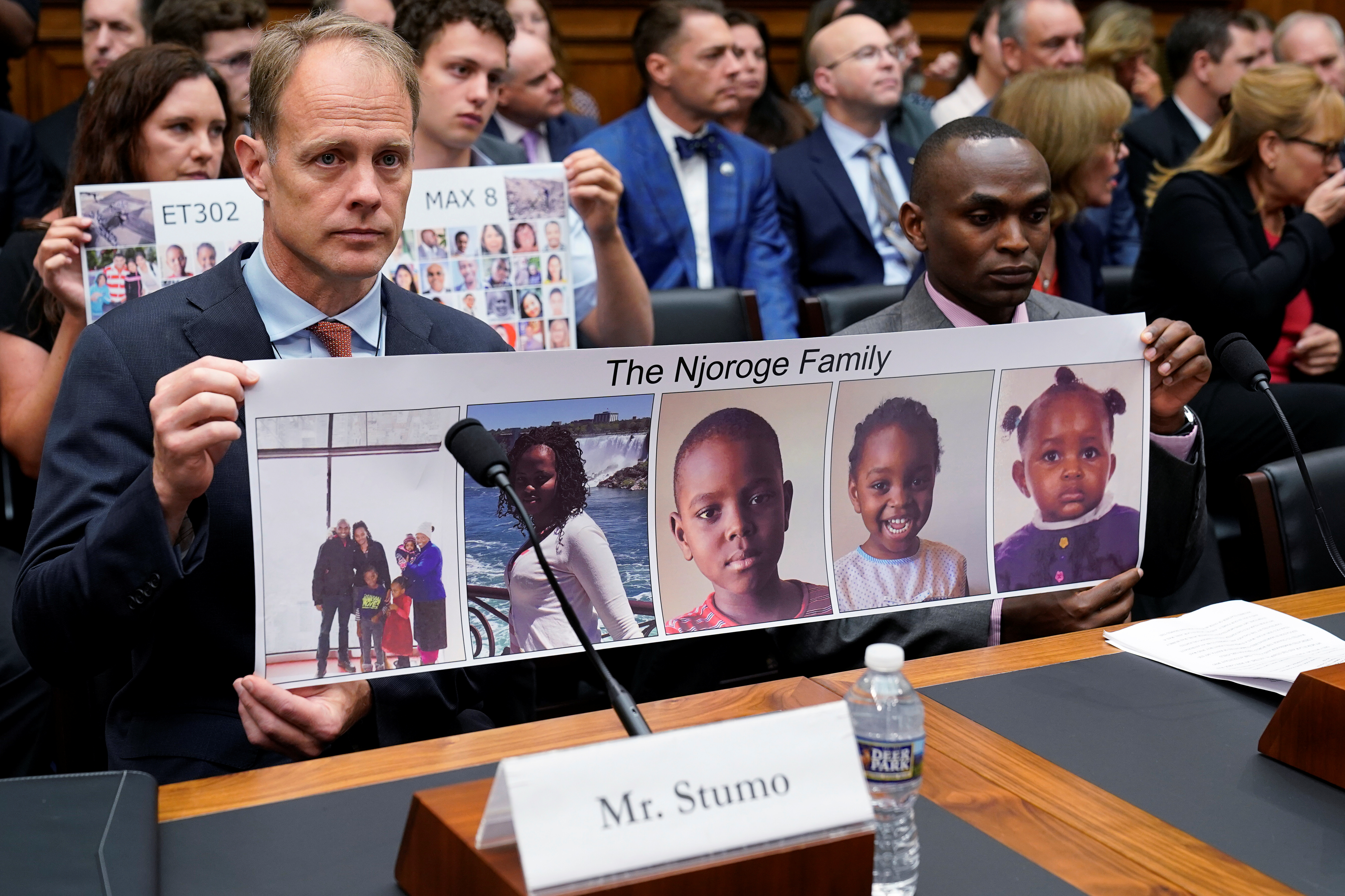 Family members of Ethiopian Airlines Flight 302 victims holding photos of their loved ones during a House Transportation hearing.