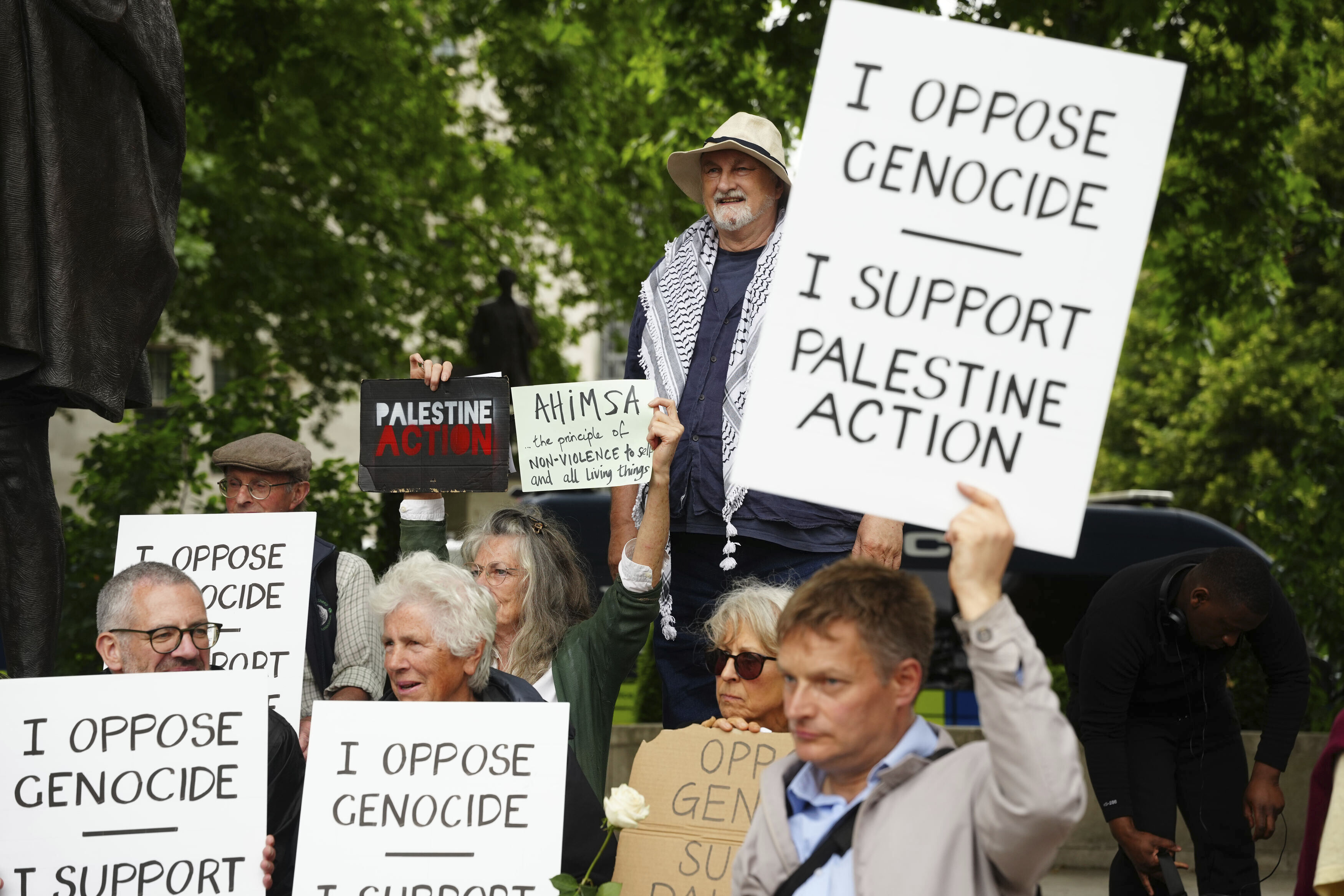 Protestors in London holding signs that say 