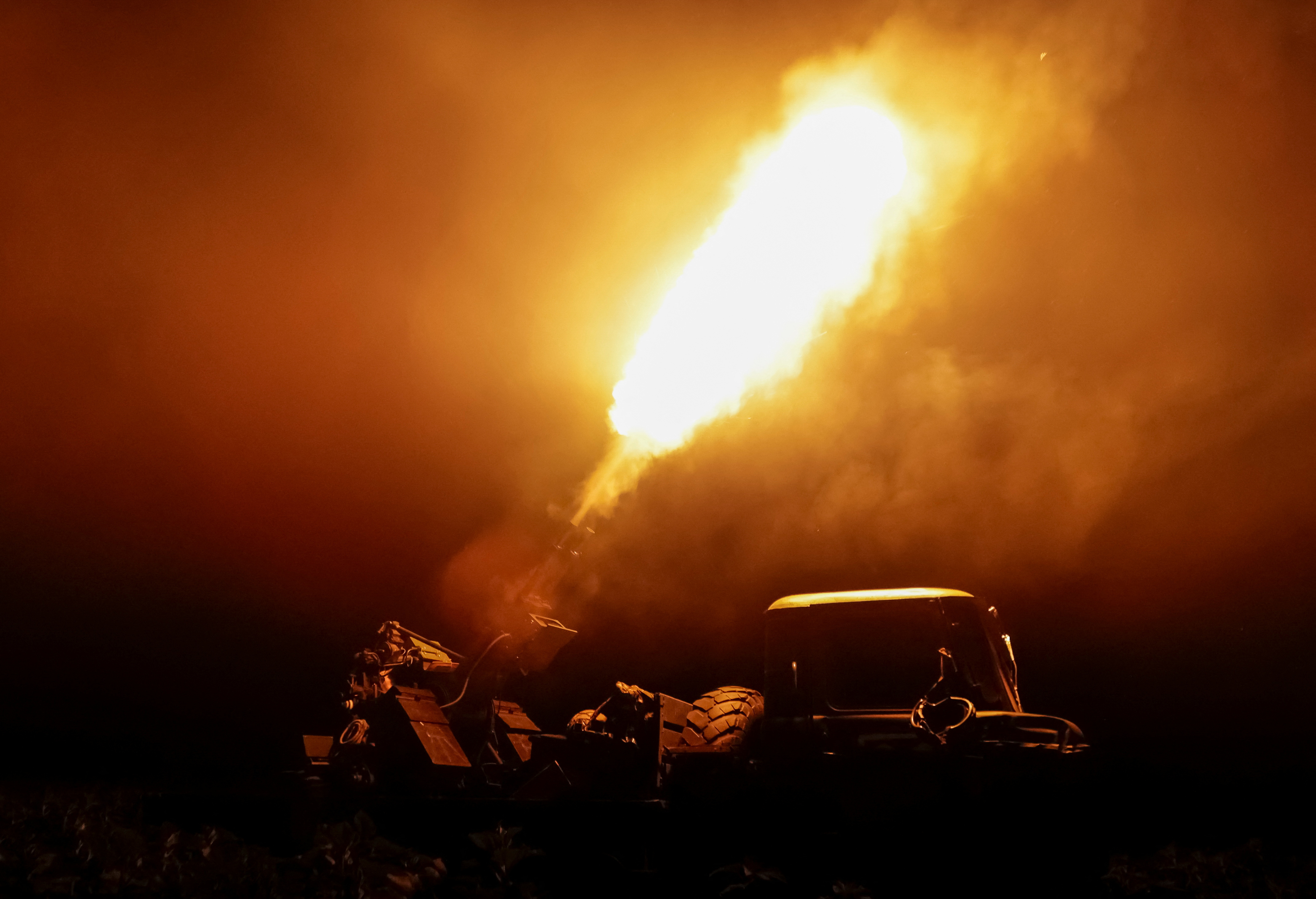 Ukrainian anti-drone unit firing ZPU-2 anti-aircraft machine gun at night.